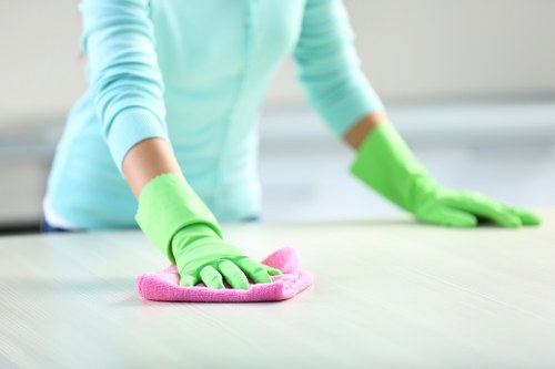 Technician performing carpet cleaning in a Beckenham workspace